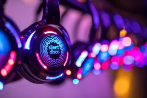 Silent discos are a style of headphone-only party where up to 3 DJs or set lists can playback simultaneously.